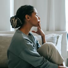 girl looking outside window worried